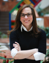 Woman in a black top with glasses